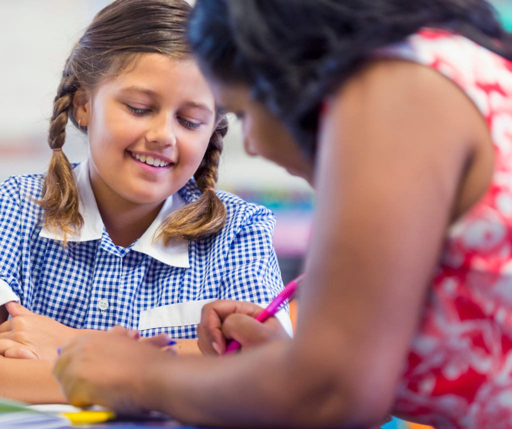 Two school girls engaging in literacy programs