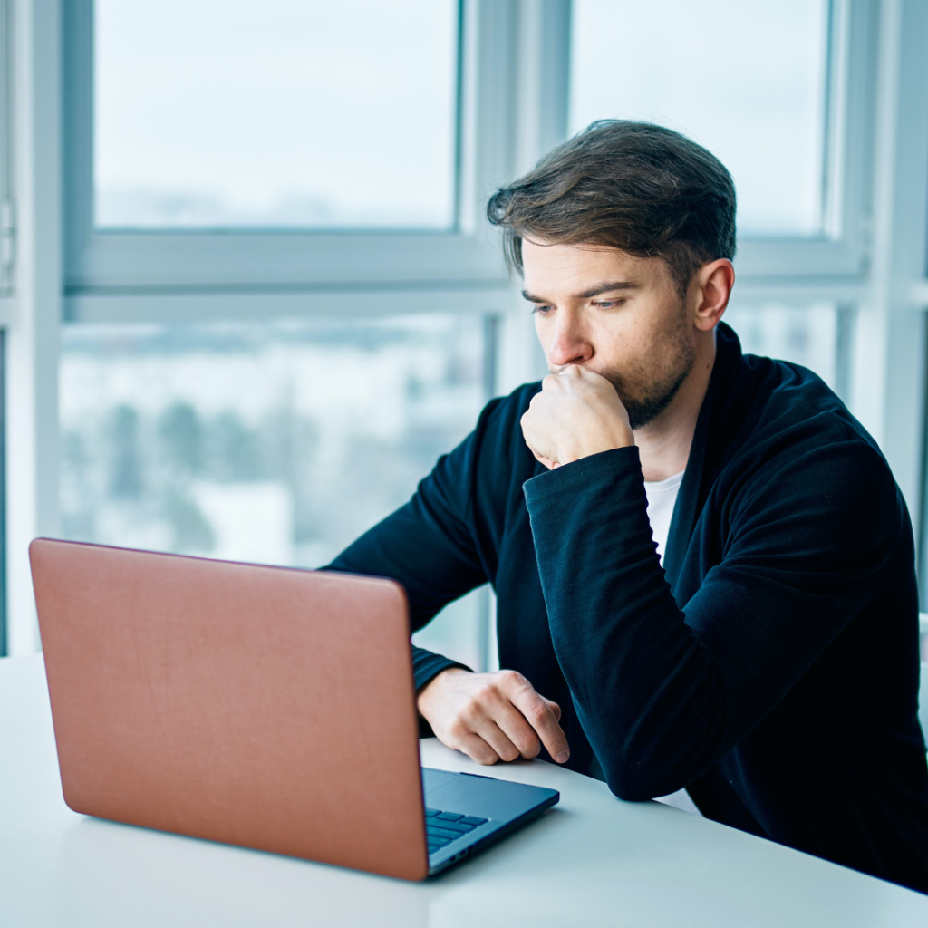 Man looking at his website on his laptop