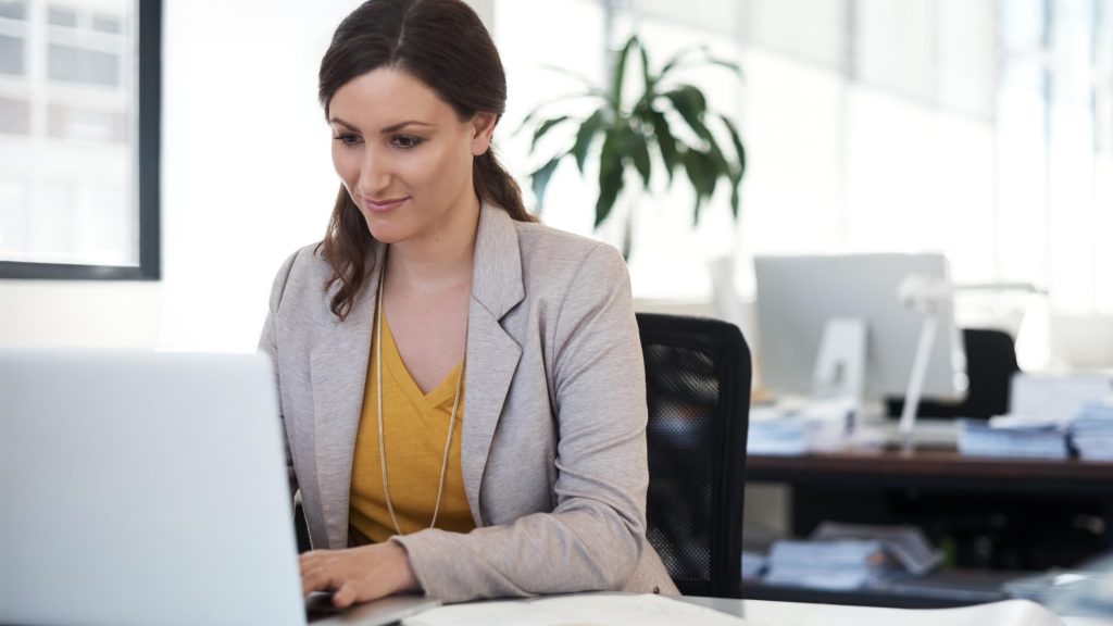Woman working on her laptop on social media and email campaigns