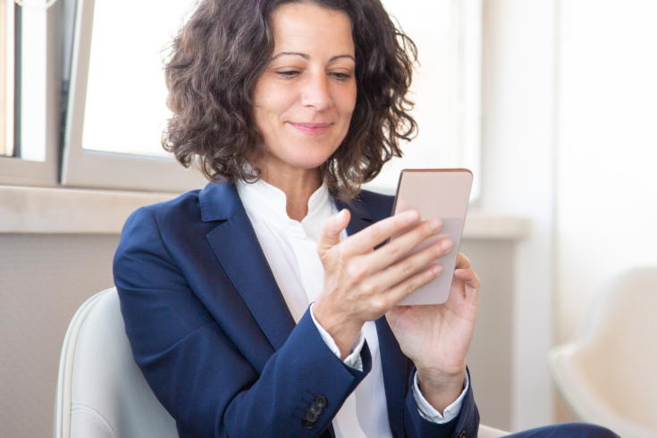 Lady engaging with website content on her phone